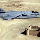 A US Navy A-7E Corsair II from attack squadron VA-72 Blue Hawks passes over a ruined fort in the Saudi desert during Operation Desert Shield in 1990. (US Navy)